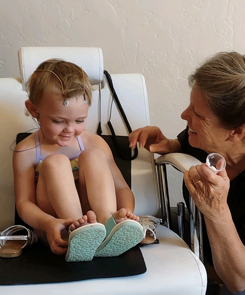 Young client receiving micro current neurofeedback (MCN) therapy to support brain function and nervous system balance at Brain & Bio Gym in Rifle, CO